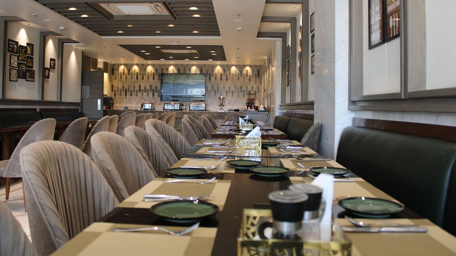 A well-arranged dining space featuring tables with chairs and neatly set cutlery at  BluSalzz Residence, Amritsar